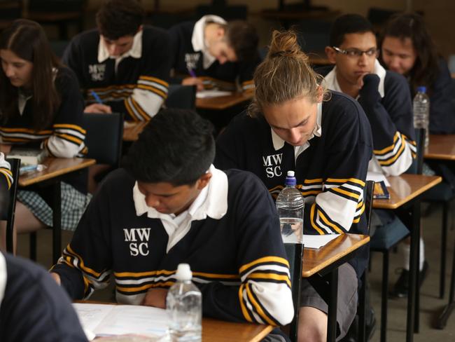 Students at Mount Waverley senior school after English VCE exam.Caleb Benson ponders his English paper.Picture: Stuart Milligan