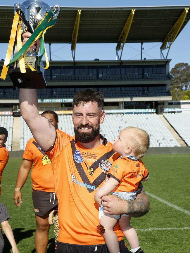 Proud skipper: Christian Nahlous with his son Coah after The Oaks’ grand final win. Picture: John Appleyard