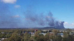 Smoke rises from the Molendinar fire.