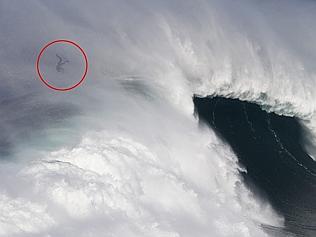 Surfer gets thrown off enormous wave