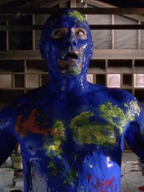 Hal is seen pouring paint all over himself.