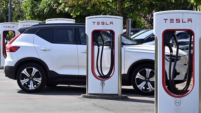 A Tesla electric vehicle charges at a station in Nivelles, on August 26, 2024. (Photo by ERIC LALMAND / Belga / AFP) / Belgium OUT