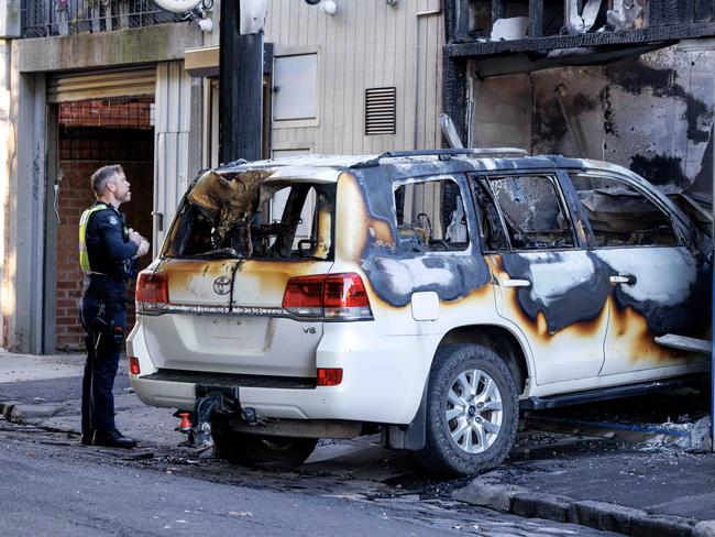 MELBOURNE, AUSTRALIA - NewsWire Photos  APRIL 21, 2025: Police inspect a burnt out car at the scene of as shop fire in Yarraville Picture: NewsWire / David Geraghty