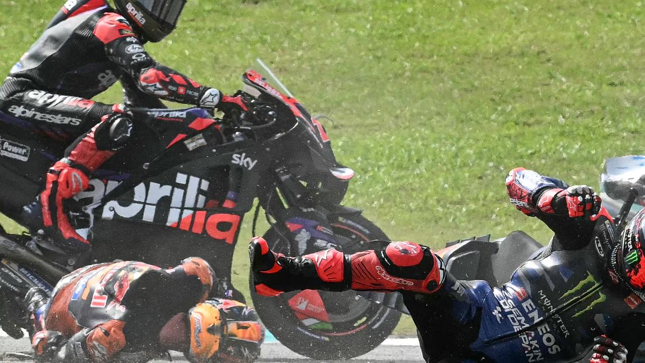 TOPSHOT - Monster Energy Yamaha MotoGP's French rider Fabio Quartararo (R) and Red Bull KTM Factory's Australian rider Jack Miller (2L) fall after a collision during the MotoGP Malaysian Grand Prix at the Sepang International Circuit in Sepang on November 3, 2024. (Photo by MOHD RASFAN / AFP)