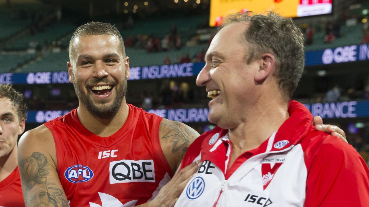 Buddy and Swans coach John Longmire. Photo: AAP Image/Craig Golding