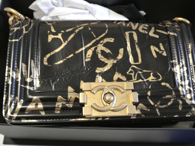 Officers allegedly seized several designer handbags, including a number of Chanel and Prada items.