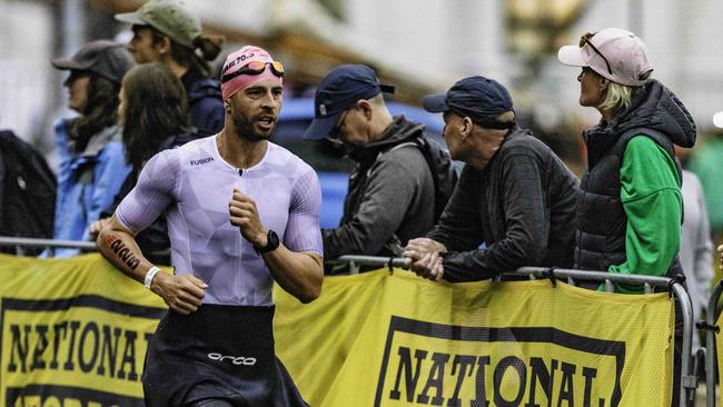Josh Griffiths returns from the swimming leg at the Ironman 70.3 Tasmania in Hobart on Sunday 4th February. Picture: Linda Higginson