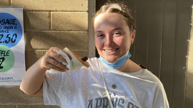 Millie Casey, 20 enjoying her first democracy sausage at Fulham Gardens Community Centre. Picture: Brinley Duggan