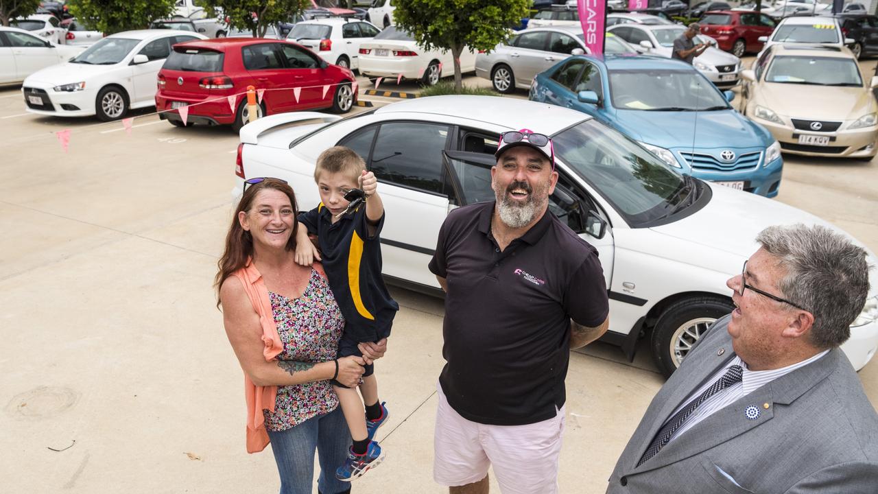 Deanne and Jax Carey with Lifeline Darling Downs and South West CEO Derek Tuffield (right) and Cheap Cars Toowoomba manager Les Hollist as she picks up her 2004 Holden Commodore donated by the organisations, Monday, March 1, 2021. Picture: Kevin Farmer