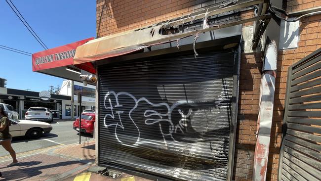 A Burleigh Heads tobacconist was badly damaged by fire after a bin was set alight next to the stores entrance.