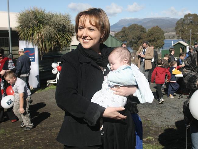 Giddings, as deputy premier in 2008, takes the opportunity to cuddle a baby at a community event at Bridgewater.