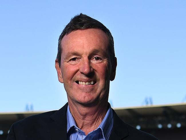 Former AFL player Neale Daniher poses for a photo with a copy of his book When All is Said & Done at the Melbourne Cricket Ground in Melbourne, Thursday, October 24, 2019. (AAP Image/Julian Smith) NO ARCHIVING