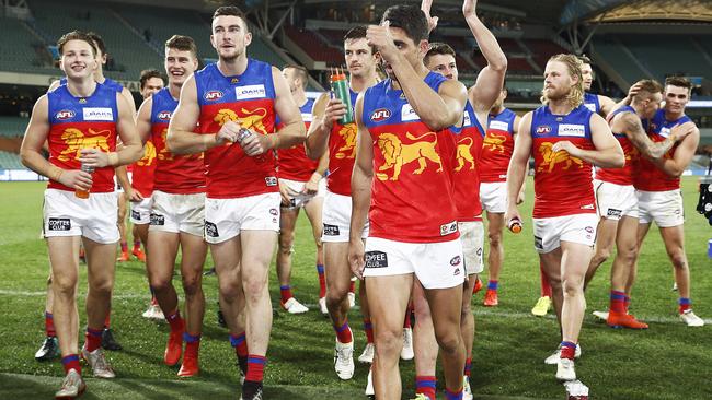 Charlie Cameron leads his team off the field after Brisbane’s big win.