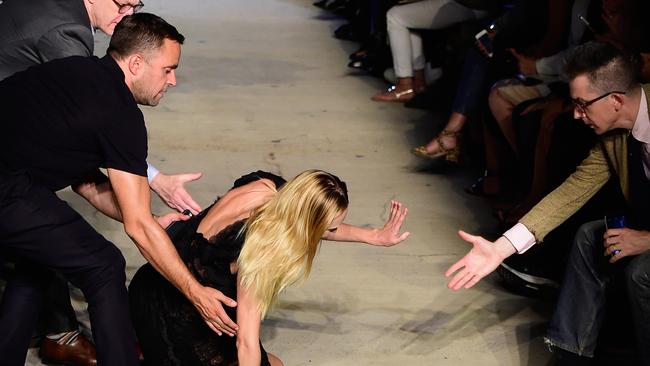 NEW YORK, NY - SEPTEMBER 11: Model Candice Swanepoel falls on the runway wearing Givenchy Spring 2016 during New York Fashion Week at Pier 26 at Hudson River Park on September 11, 2015 in New York City. (Photo by Frazer Harrison/Getty Images)