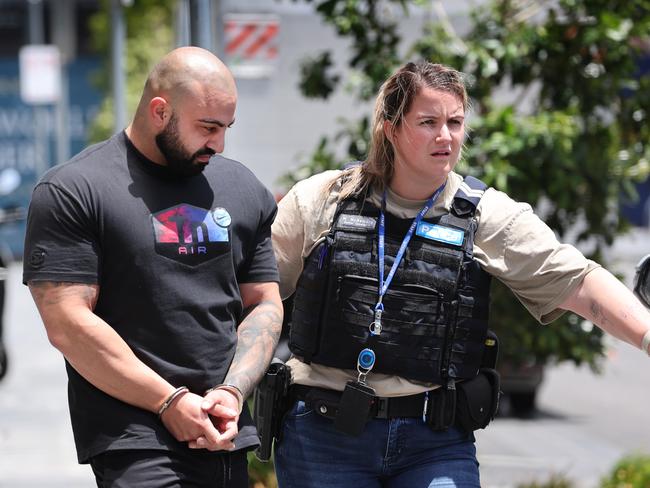 Daniel Tenace pictured. Alleged drug arrests Docklands. Two men arrested from an apartment tower in Docklands over a drugs. Police officers escort one of the men to a police car.                       Picture: David Caird