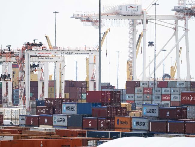 (FILES) Cargo shipping containers and cranes are seen at cargo terminals as part of the Port of Baltimore in Baltimore, Maryland, June 12, 2024, following the reopening of the shipping channel in the Baltimore Harbor after the Francis Scott Key Bridge collapsed. US President-elect Donald Trump said November 25, 2024 he intends to impose sweeping tariffs on goods from Mexico, Canada and China, prompting a swift warning from Beijing that "no one will win a trade war." In a series of posts to his Truth Social account, Trump vowed to hit some of the United States' largest trading partners with duties on all goods entering the country. (Photo by SAUL LOEB / AFP)