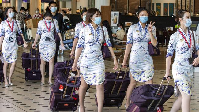 Flight staff at Brisbane International Airport today. Picture: AAP