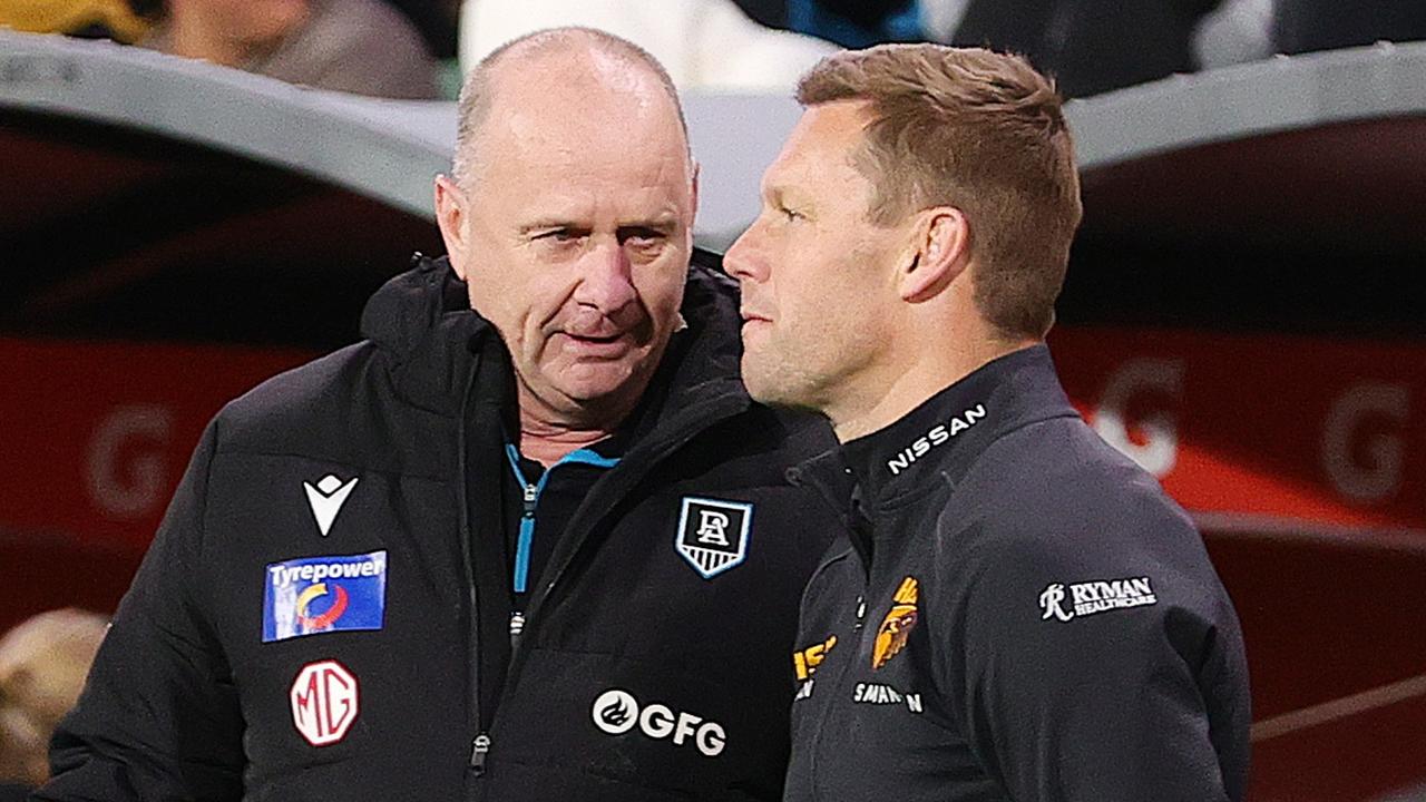 Ken Hinkley and Sam Mitchell speak after the match. Photo by Sarah Reed/AFL Photos via Getty Images.