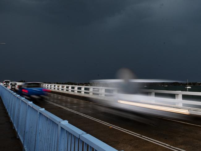 A storm cell passes over the bridge to Bribe Island as wild weather lashes south east Queensland. Photo Lachie Millard