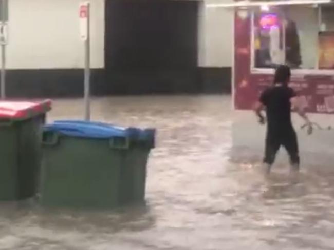 A person wades through floodwaters in Ballarat.