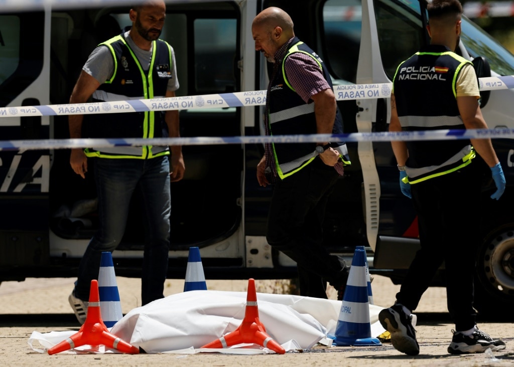Police officers attended the scene next to the body of ex-Ukraine MP Andriy Portnov after he was shot dead in Pozuelo de Alarcon, near Madrid