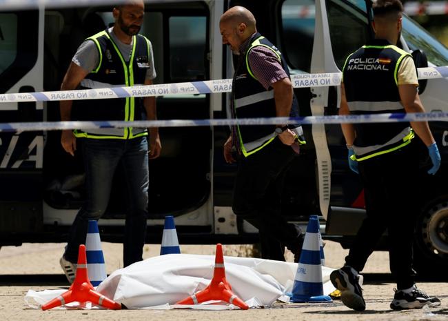 Police officers attended the scene next to the body of ex-Ukraine MP Andriy Portnov after he was shot dead in Pozuelo de Alarcon, near Madrid