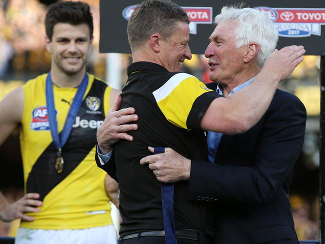 Richmond coach Damien Hardwick gets the Jock McHale medal from Mick Malthouse . Pic: Michael Klein