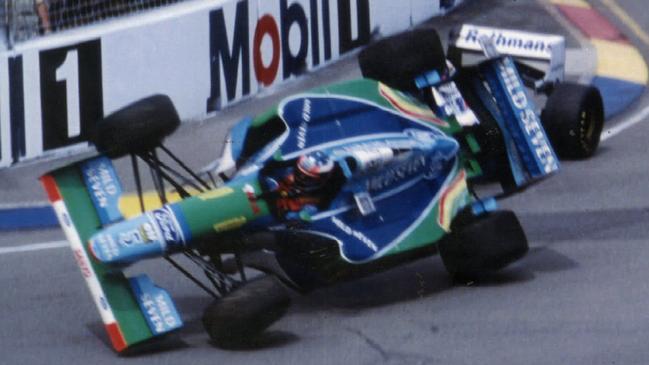 German driver Michael Schumacher of Benetton-Ford on two wheels after clipping Briton Damon Hill during the 1994 race.