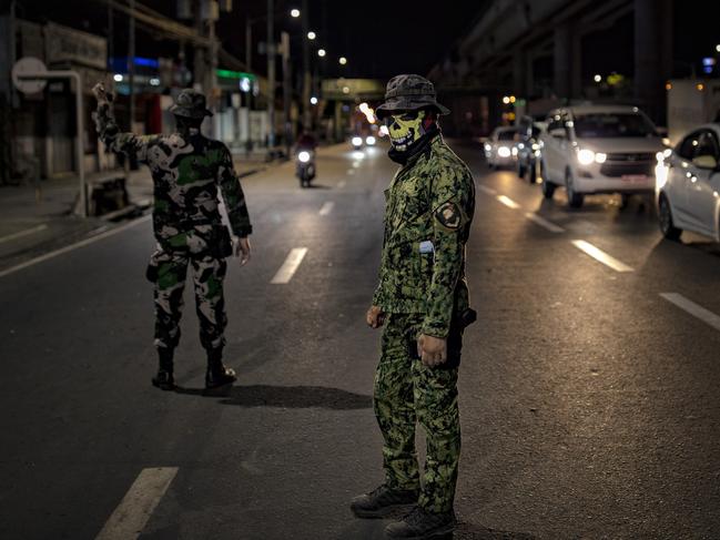 A policeman wearing a mask mans a quarantine checkpoint in Marikina, Metro Manila, Philippines. Picture: Getty Images