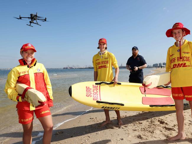 South Melbourne Life Saving Club members Ryhs Lewis 17yrs , Daisy Graham 18yrs , Katherine Hargest 13yrs and Drone Pilot Operator James Coutie on South Melbourne beach as the season draws to a close. Picture: Ian Currie