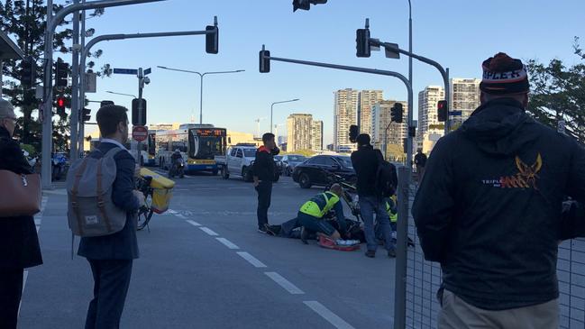 Paramedics treat an injured motorcyclist at a Brisbane CBD intersection. Photo: Sophie Chirgwin