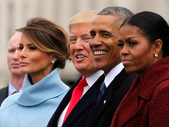 U.S. President Donald Trump (C) and first lady Melania Trump (L). Mrs Trump’s inaugural speech borrowed heavily from one delivered by Michelle Obama (R). Picture: Reuters