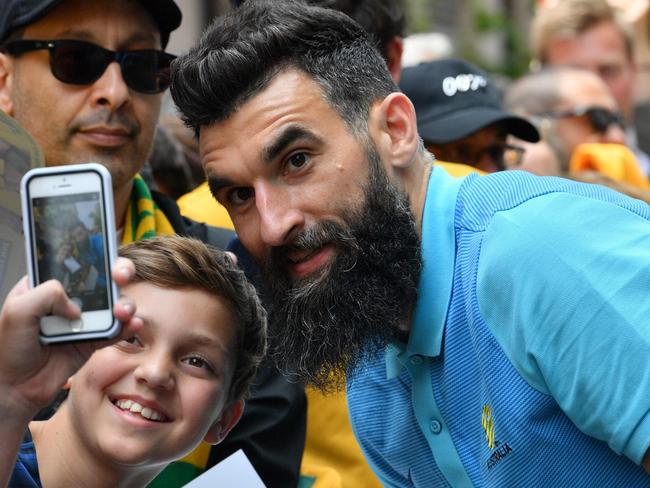 Australia's captain Mile Jedinak poses for a photograph during an event to celebrate the teams qualification for the 2018 football World Cup, in Sydney on November 16, 2017. Australia reached their fourth-straight World Cup after defeating Honduras in a 3-1 aggregate playoff victory in the qualifiers, with Mile Jedinak scoring a hat-trick. / AFP PHOTO / SAEED KHAN / IMAGE RESTRICTED TO EDITORIAL USE - STRICTLY NO COMMERCIAL USE