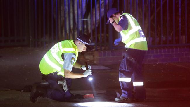 Police officers check the scene of the accident after an elderly male was run over while crossing Burwood Road, Belmore. Picture: Bill Hearne