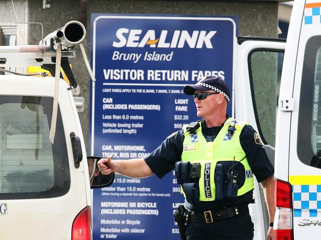 Tasmanian police patrol and check vehicles at the Bruny Island Ferry in Kettering.  Picture: Zak Simmonds