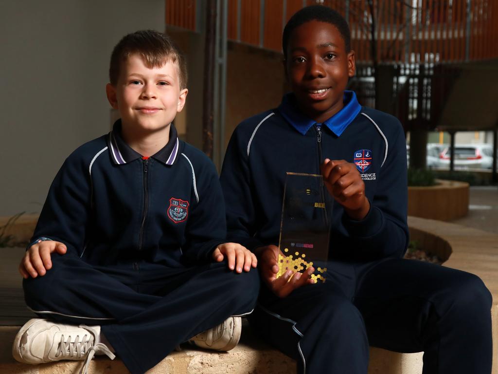 National champion in the Green category (Years 3-4), Samuel Wright is pictured with fellow Providence Christian College student, last year's winner and this year's runner up in the Orange category (Years 5-6), Ozi Egesi, holding his 2022 trophy, presented in Canberra by Prime Minister Anthony Albanese. Picture: Philip Gostelow