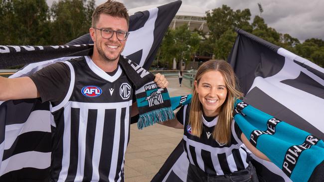 Port Adelaide fans Andrew Fuss and Ruby McHaffie on the Adelaide Oval footbridge, which will be awash with supporters before the Showdown on Saturday. Picture: Ben Clark