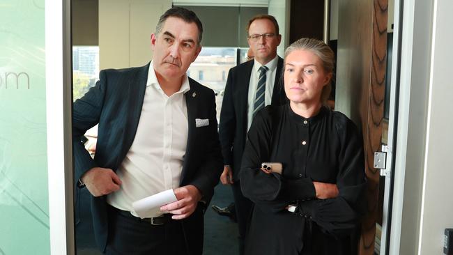 Paul Scurrah, left, with a media adviser and Vaughan Strawbridge of Deloitte, rear, in Sydney on Tuesday Picture: John Feder