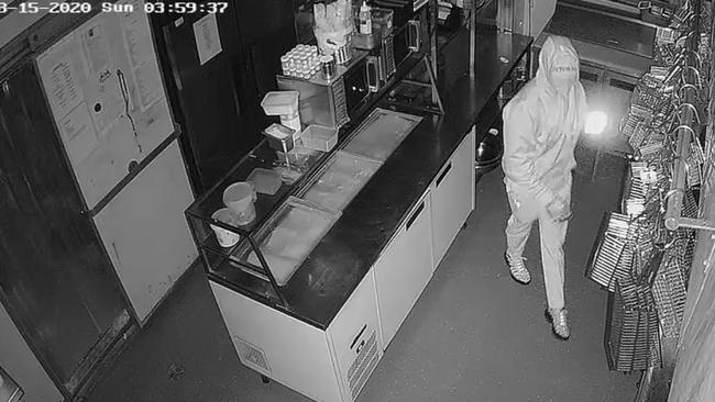 A suspect in the kitchen of Table 1 Espresso at Warners Bay after entry was gained about 3.55am on March 15. Cash and chocolates were stolen. Picture: supplied