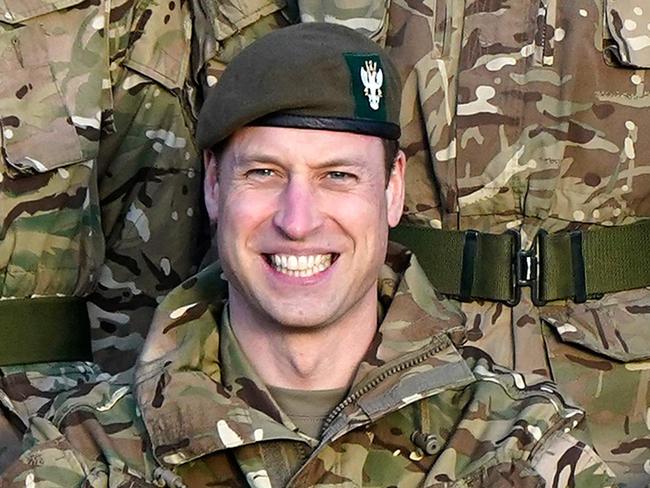 Britain's Prince William, Prince of Wales (C), in his role as Colonel-in-Chief, 1st Battalion Mercian Regiment, wears Army fatigues as he sits alongside alongside Lieutenant General Ian Cave (R) for a group photograph, during a visit to the regiment, near Salisbury, south west of England on November 23, 2023. (Photo by Andrew Matthews / POOL / AFP)