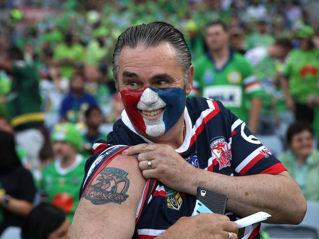 A Roosters fan shows off his chook tattoo as he goads the Canberra Raiders fans. Picture: Phil Hillyard