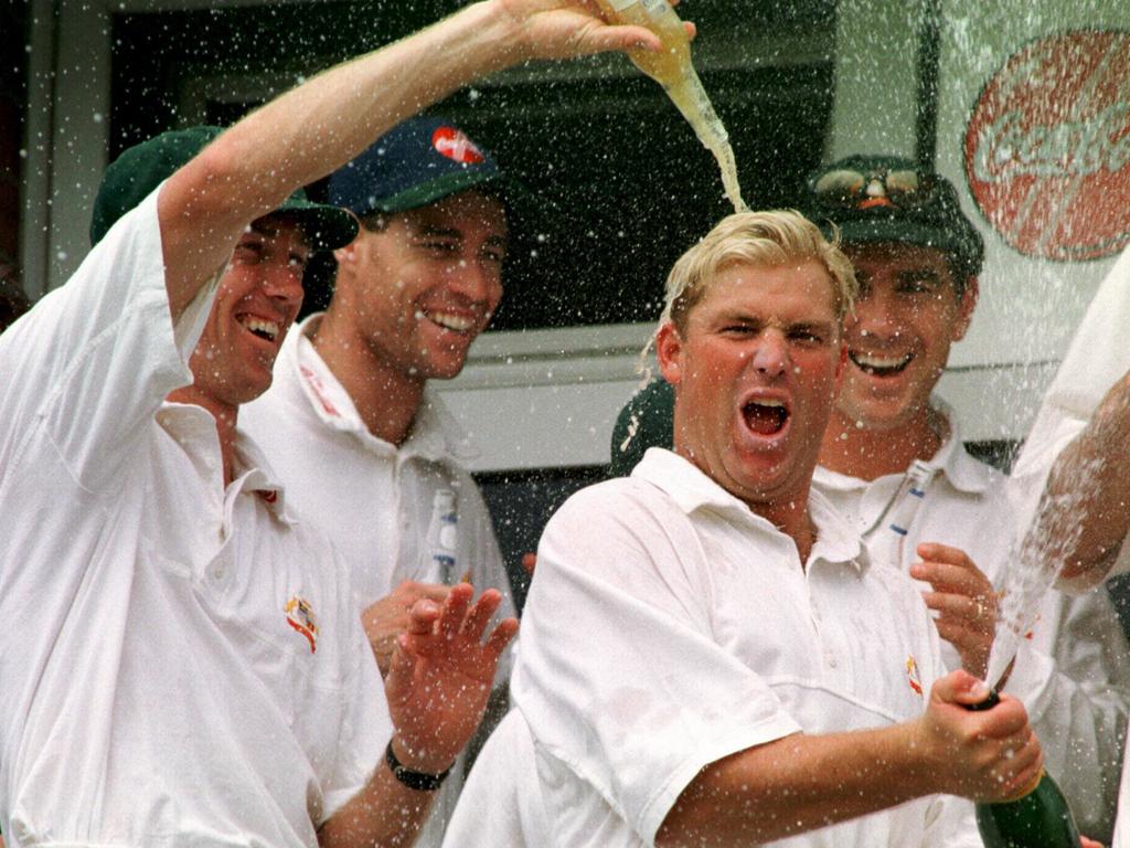 Shane Warne celebrate with champagne after an Australian Test victory over England.