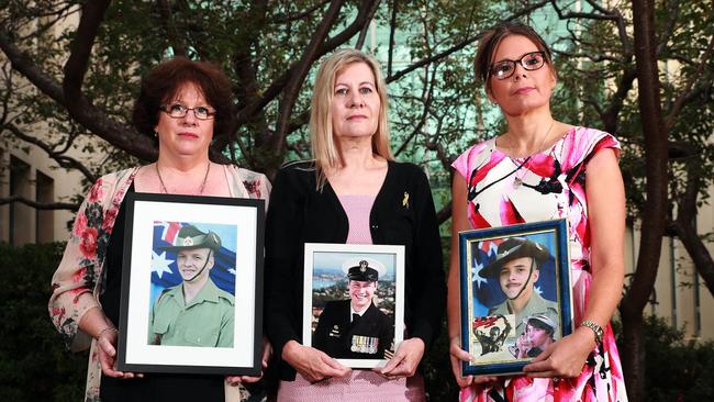 Mothers Colleen Pillen, Julie-Ann Finney and Nikki Jamieson held framed pictures of their veterans sons who took their life. Picture Gary Ramage