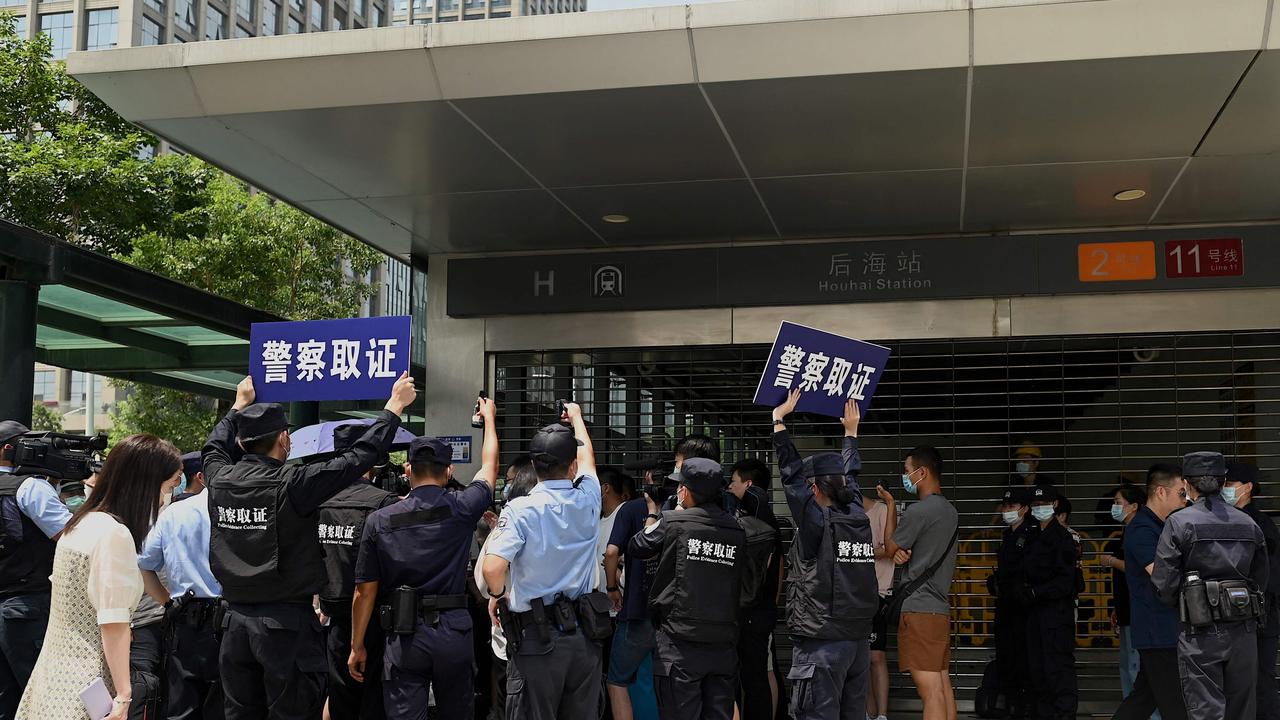 People gather at the Evergrande headquarters in Shenzhen, southeast China, as the property giant said it is facing ‘unprecedented difficulties’. Picture: Noel Celis/AFP