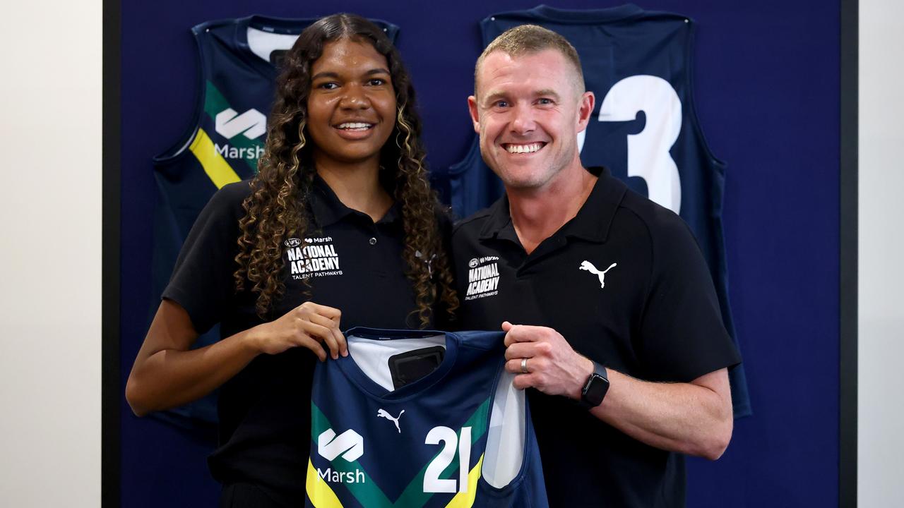 Danika McDonald of the AFL National Academy is presented her jumper by AFL National Academy Manager and Head Coach Tarkyn Lockyer. Picture: Josh Chadwick/AFL Photos