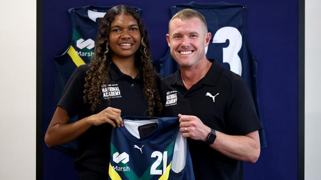 Danika McDonald of the AFL National Academy is presented her jumper by AFL National Academy Manager and Head Coach Tarkyn Lockyer. Picture: Josh Chadwick/AFL Photos