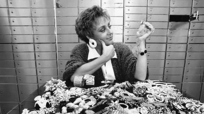 1990: Wills in the depths of the historic King William St branch of the State Bank depositing her jewellery in the bank's new safe deposit boxes. Pictured deciding which earrings to keep, July, 1990.