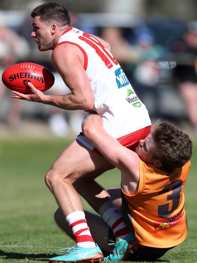 Ararat’s Jack Ganley is tackled by Giants player Heath Smith.