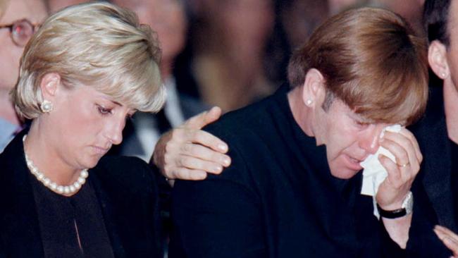 Diana, Princess of Wales sits next to singer Elton John at Gianni Versace’s memorial mass.