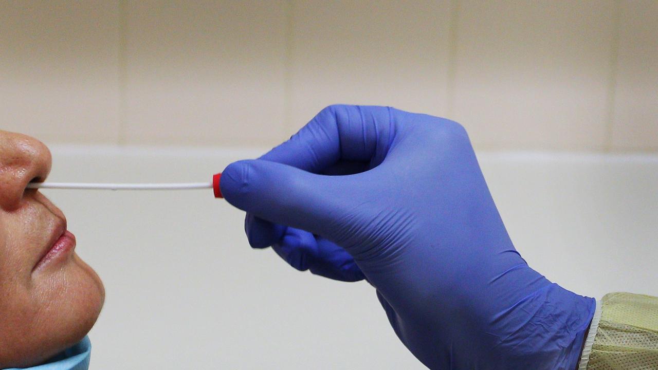 A nasal swab test is conducted in the clinical assessment room at St George Hospital COVID-19/ Flu Assessment Clinic in Sydney. Picture: Lisa Maree Williams